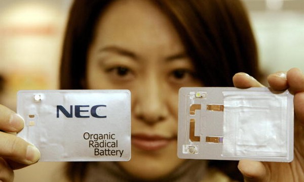 An employee of NEC shows off a card-size